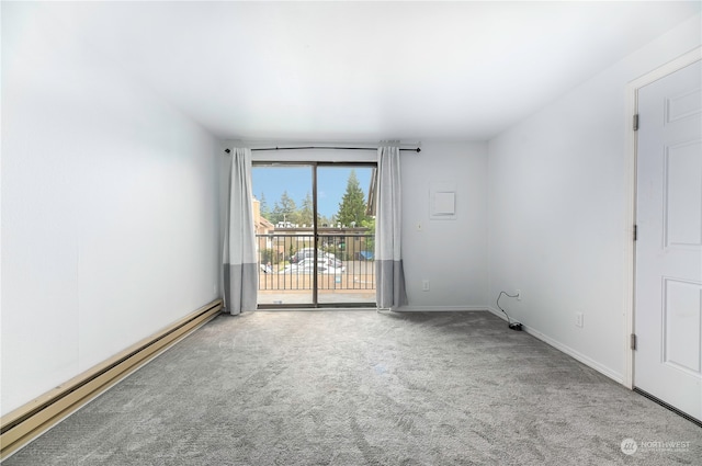 unfurnished room with a baseboard heating unit and carpet floors