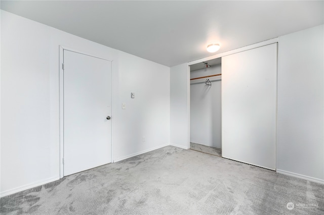 unfurnished bedroom with a closet and carpet floors