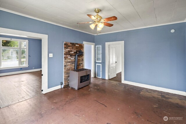 unfurnished living room featuring crown molding, a wood stove, heating unit, ceiling fan, and a baseboard heating unit