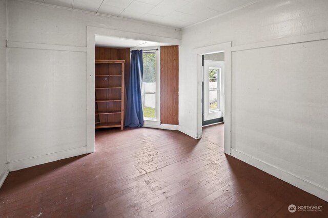 unfurnished room with dark hardwood / wood-style flooring