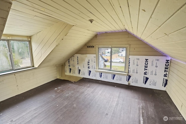 additional living space featuring vaulted ceiling, wood walls, wood ceiling, and hardwood / wood-style flooring