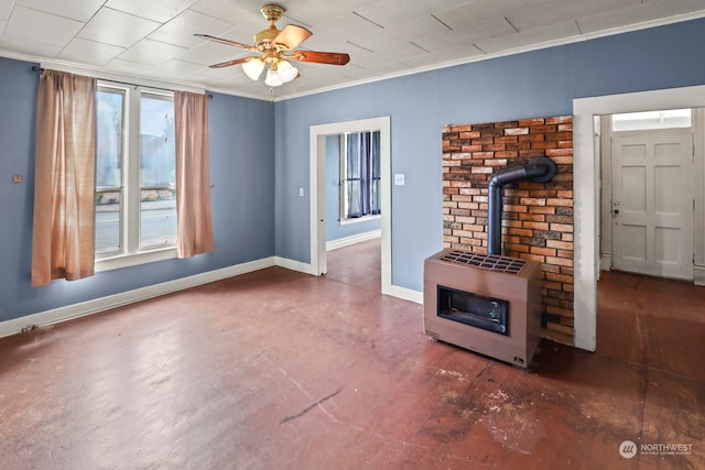 unfurnished living room featuring crown molding, a wood stove, heating unit, and ceiling fan