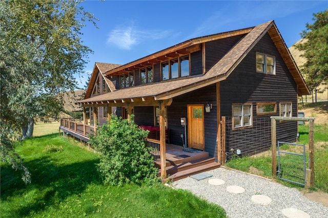 rear view of property featuring a lawn