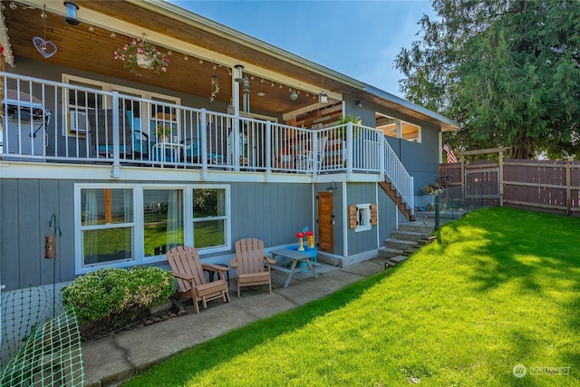 back of house with a lawn and a patio area