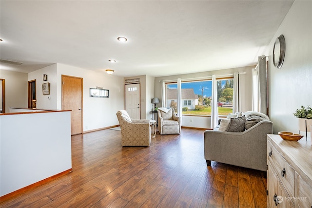 living room with dark hardwood / wood-style flooring