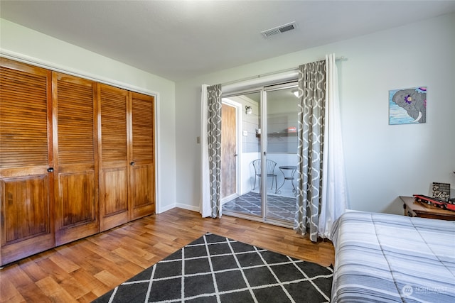 bedroom with hardwood / wood-style floors and a closet