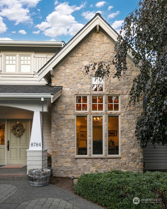 entrance to property with a shingled roof