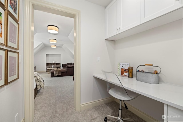 home office featuring carpet flooring, baseboards, and built in study area