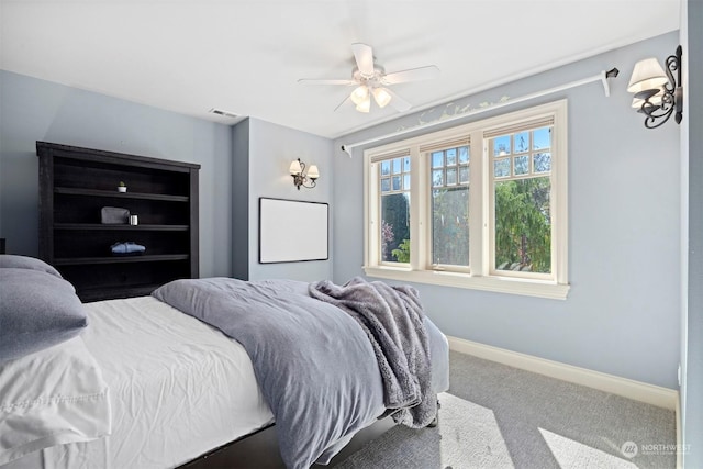 carpeted bedroom featuring visible vents, baseboards, and ceiling fan