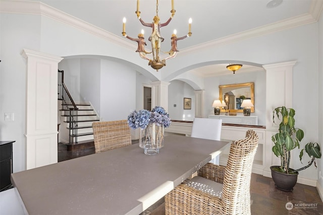 dining room featuring ornate columns, stairs, a chandelier, and crown molding