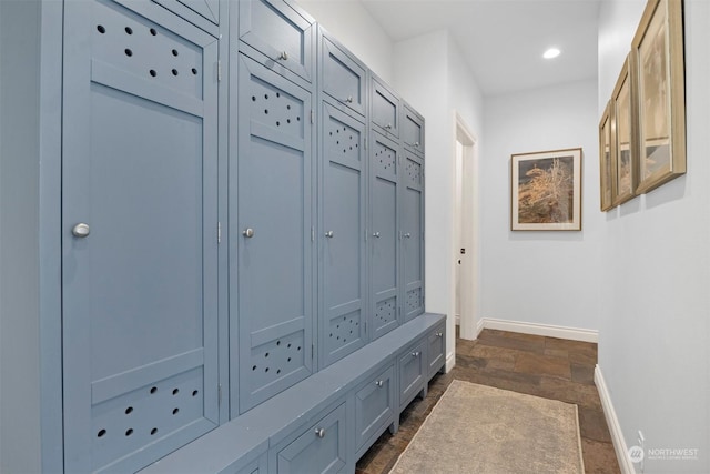 mudroom featuring stone finish flooring, baseboards, and recessed lighting