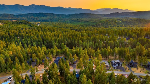 aerial view at dusk featuring a mountain view