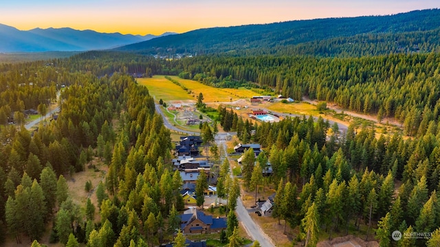 aerial view at dusk featuring a mountain view