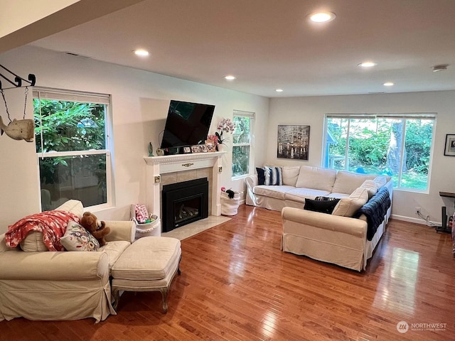 living room featuring hardwood / wood-style floors and a tile fireplace