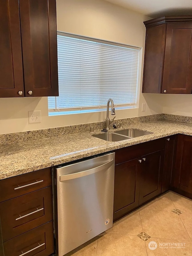 kitchen featuring dishwasher, light tile patterned floors, sink, light stone counters, and dark brown cabinetry