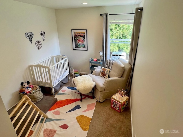 carpeted bedroom with a crib