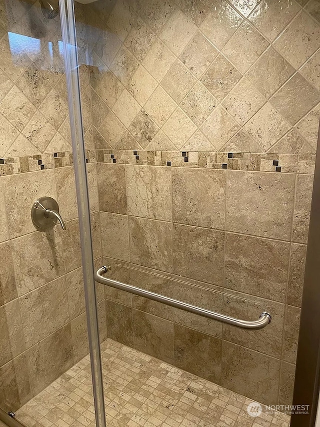 bathroom featuring a shower with door