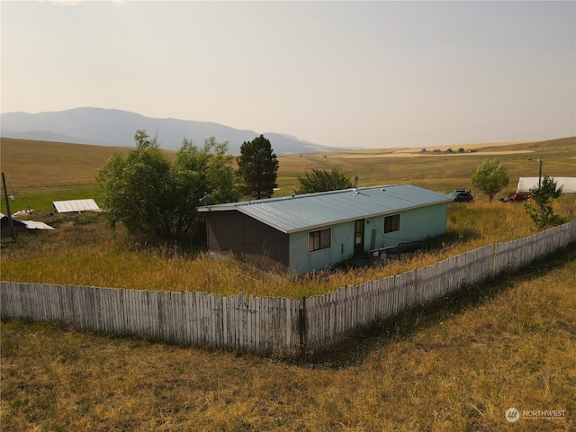 view of side of home with a mountain view and a rural view