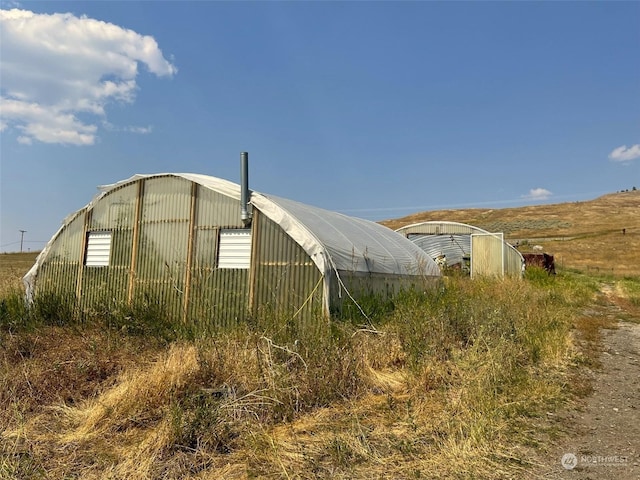 view of property exterior featuring an exterior structure and an outdoor structure