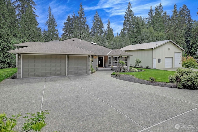 ranch-style home featuring a garage and a front lawn