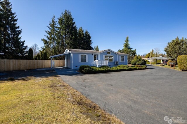 ranch-style home with a carport and a front lawn