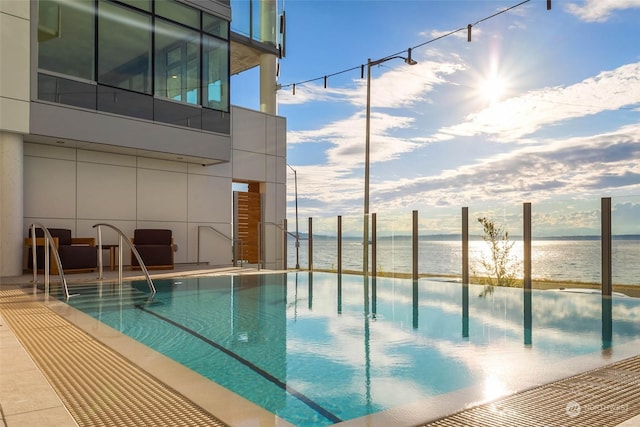 view of swimming pool with a water view