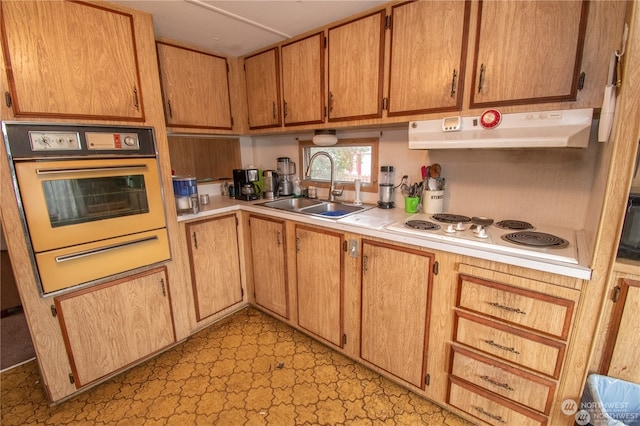 kitchen featuring oven, sink, and white electric stovetop