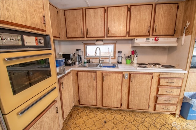 kitchen featuring sink, white appliances, and light tile patterned flooring