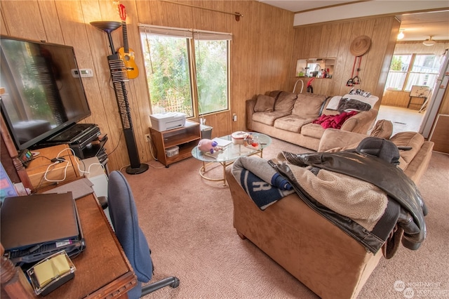 living room featuring carpet, wood walls, and beam ceiling