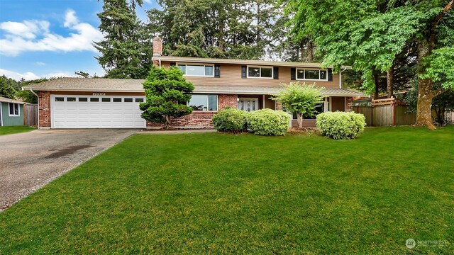 view of front of house with a garage and a front yard