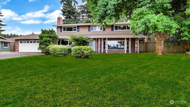 view of front of house with a garage and a front yard