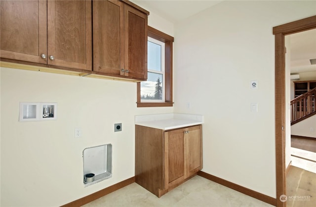 clothes washing area with cabinets, washer hookup, and hookup for an electric dryer