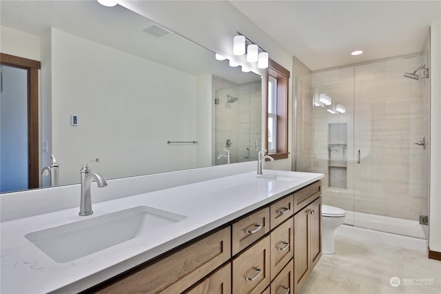 bathroom with walk in shower, vanity, and toilet