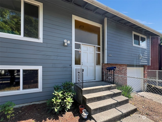 doorway to property featuring a garage