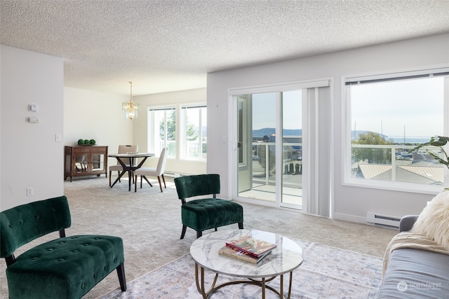 carpeted living room with baseboard heating, a chandelier, and a textured ceiling