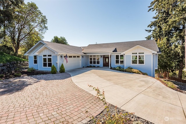 ranch-style home featuring an attached garage, driveway, and board and batten siding