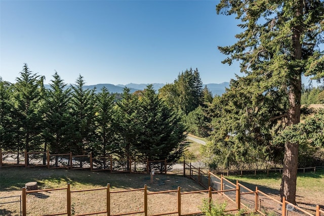 exterior space with fence and a mountain view