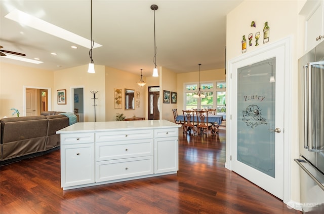 kitchen featuring white cabinetry, decorative light fixtures, ceiling fan, and dark hardwood / wood-style floors