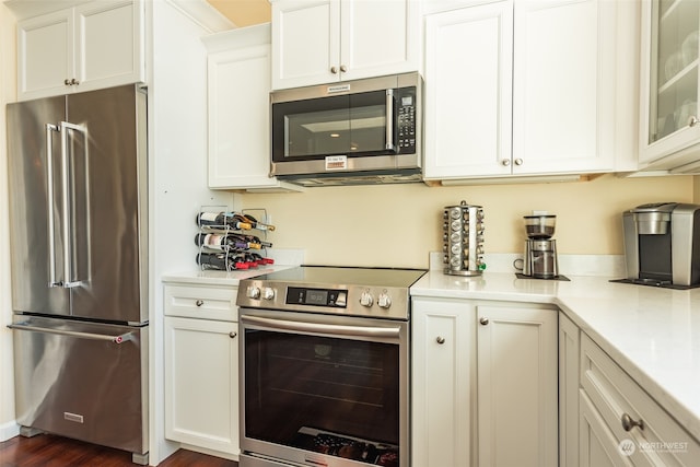 kitchen with white cabinetry, dark hardwood / wood-style flooring, and stainless steel appliances