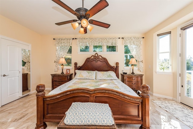 bedroom featuring access to exterior, ceiling fan, and baseboards