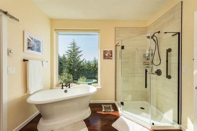 bathroom featuring separate shower and tub and hardwood / wood-style flooring