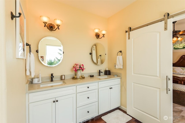 full bathroom with connected bathroom, a sink, and double vanity