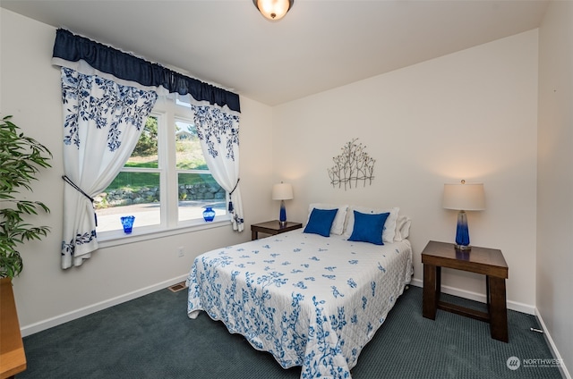 bedroom with dark colored carpet