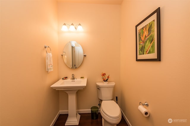 bathroom featuring toilet and hardwood / wood-style flooring