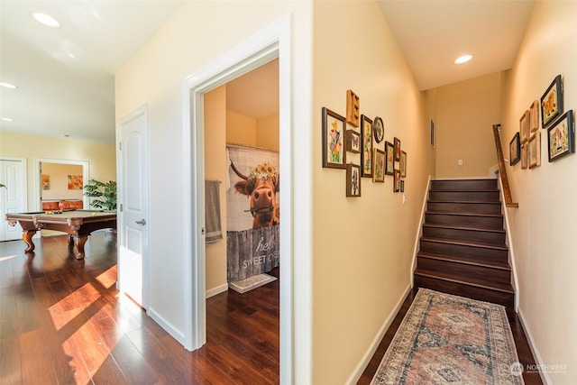 hallway with baseboards, stairway, and dark wood-style flooring