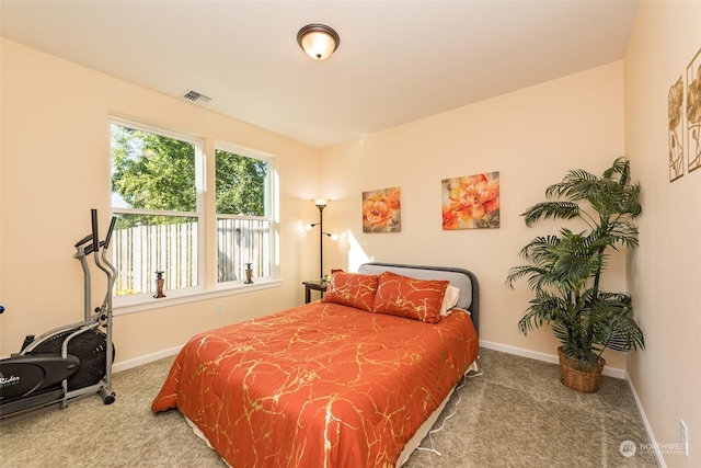 carpeted bedroom featuring baseboards and visible vents