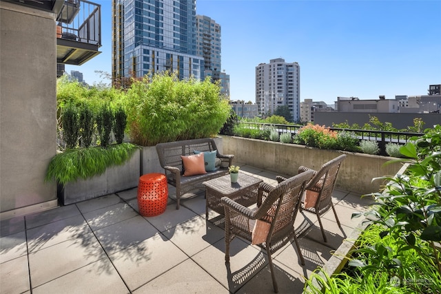 view of patio / terrace with an outdoor hangout area and a balcony