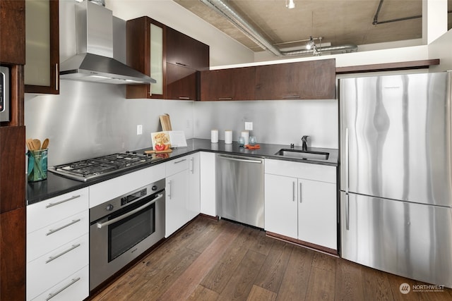 kitchen featuring sink, wall chimney exhaust hood, white cabinetry, stainless steel appliances, and dark hardwood / wood-style flooring