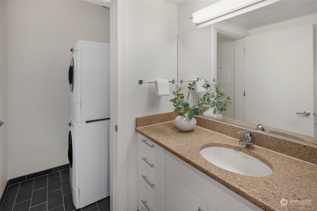 bathroom with vanity, tile patterned floors, and stacked washing maching and dryer