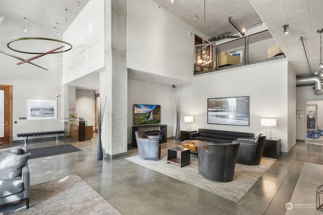 interior space featuring a high ceiling and concrete floors